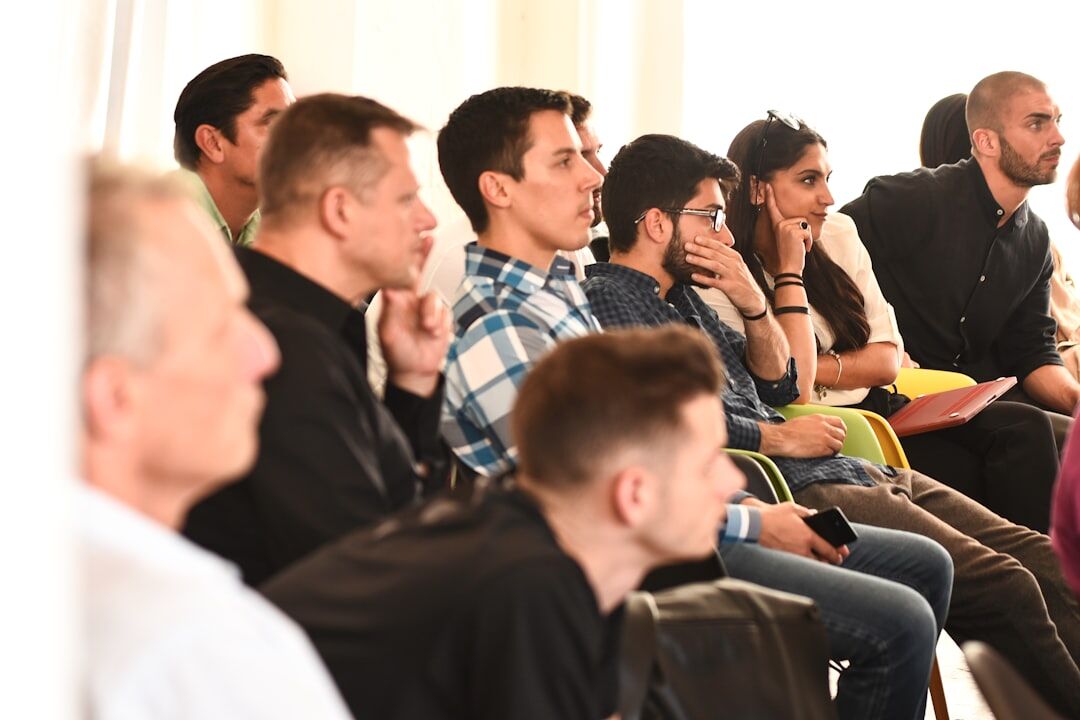 Group workshop with a trainer coaching a speaker in front of small audience